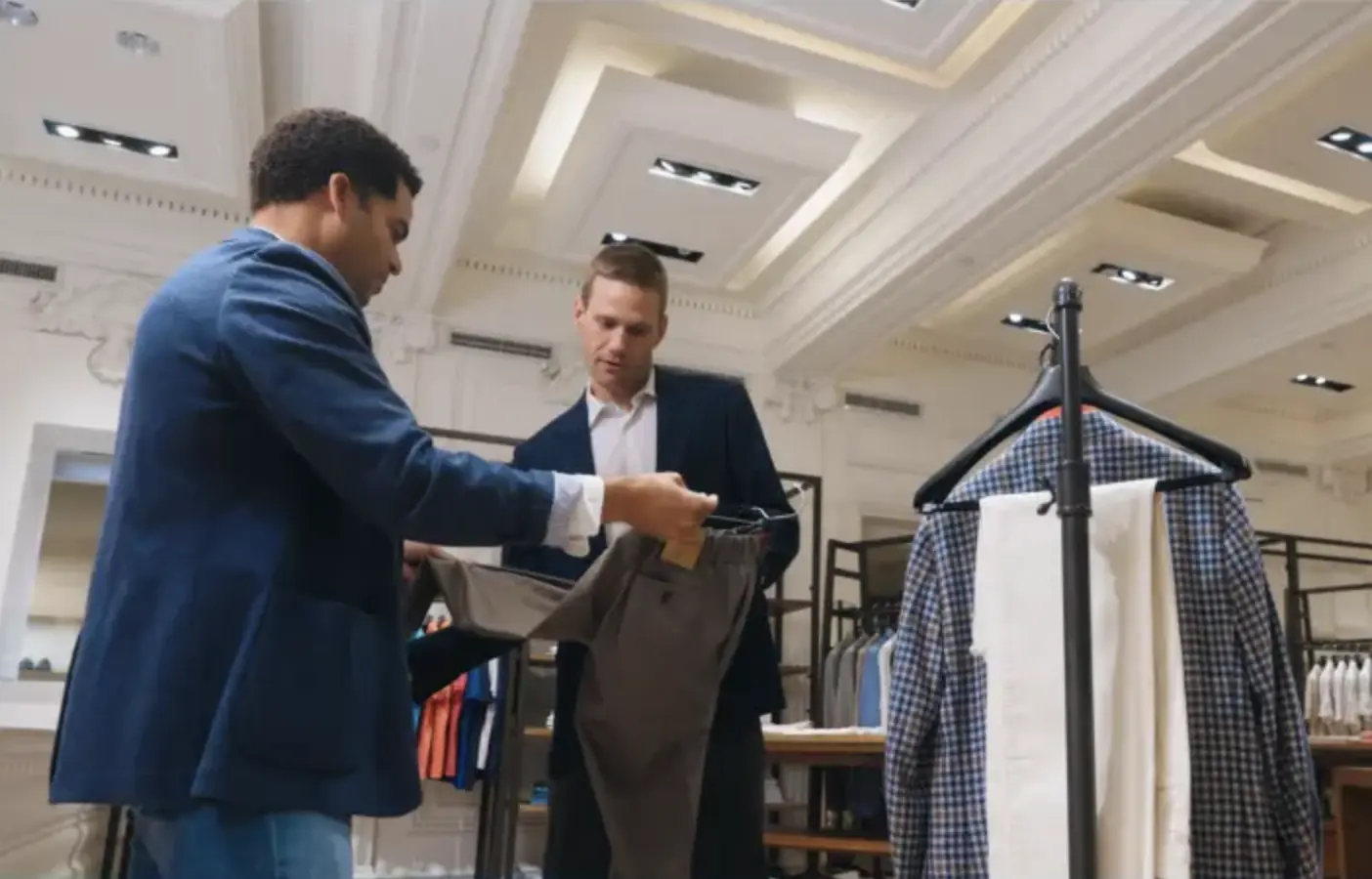 men looking at high end clothing